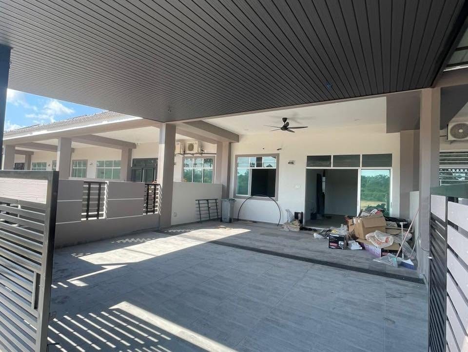 Inside the finished porch: dark slatted ceiling with a ceiling fan, the neighbouring terrace units and cartons stacked at the far end.